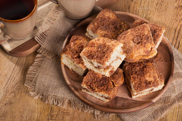 Wall Mural - Overhead view of pieces of cinnamon swirl coffee cake on a wooden plate