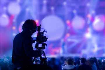 the filmmaker is recording and broadcasting live concerts on camcorders. professional video recordin