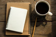 © Golden House Images - Top view of blank notebook with white coffee, laptop and with natural light on wooden table.