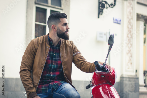 Young Male Model On Brown Leather Jacket Sitting On Italian