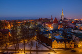 Fototapeta  - Exciting winter view of night old town of Tallinn. Aerial over roofs and towers.