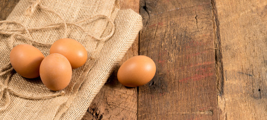 Freshly laid organic eggs on wooden bench