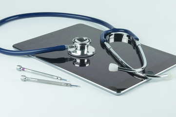 Wall Mural - Stethoscope, tablet and screwdrivers.