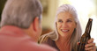 © rocketclips - Mid aged white woman drinking a beer with a male companion