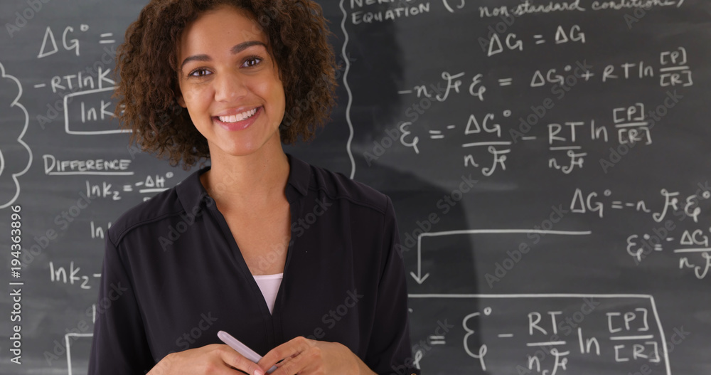 Portrait of black teacher giving math lesson on chalkboard - obrazy, fototapety, plakaty 