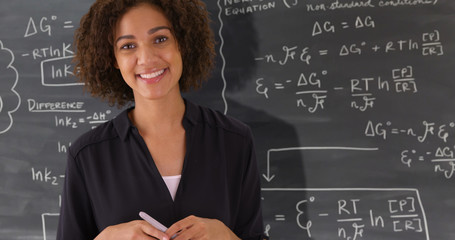 Canvas Print - Portrait of black teacher giving math lesson on chalkboard