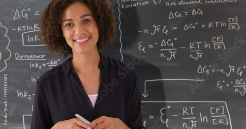 Fotografía Portrait of black teacher giving math lesson on chalkboard