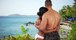 Black couple on honeymoon in Caribbean looking out over the ocean. Man and woman on vacation at island resort in love