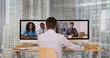 © Mark Adams - Successful group of business associates having internet based web conference over video chat. Black Hispanic and Caucasian team of office workers communicate using modern technology