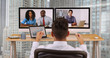 © Mark Adams - Hispanic business man in high rise corporate office having internet video conference with diverse group of coworkers. Businessman and international colleagues communicating over VoIP