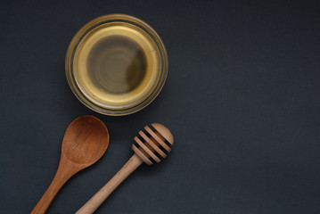 Honey in Glass bowl Isoalted with dipper over dark Background Isolated with copy space. flat Lay.