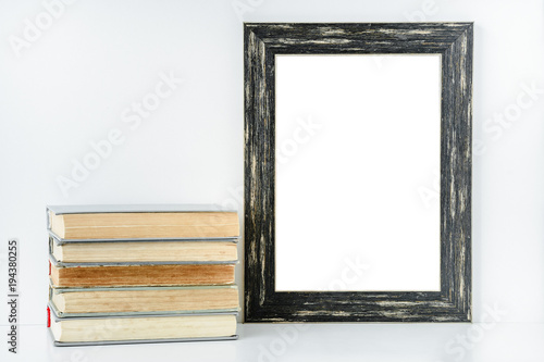 Empty Black Frame And Stack Of Old Books On White Background Empty Black Frame And Stack Of Old Books On White Background