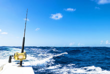 Fishing Rod In A Saltwater Boat During Fishery Day In Blue Ocean. Successful Fishing Concept