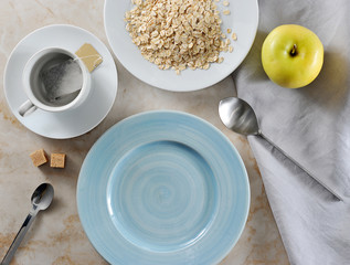 Wall Mural - preparing for Breakfast - tea bags and oatmeal with butter, yellow Apple