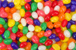 Many brightly colored jelly beans in a rainbow of colors. Popular candy for Easter.