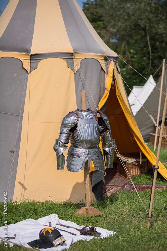 Medieval Metallic Armor and Ancient Tent in background - obrazy, fototapety, plakaty 
