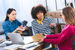 © LIGHTFIELD STUDIOS - multiracial students having discussion while doing homework together