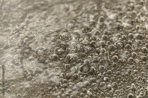 Valokuva Boiling water, close up of escaping bubbles of steam in boiling water
