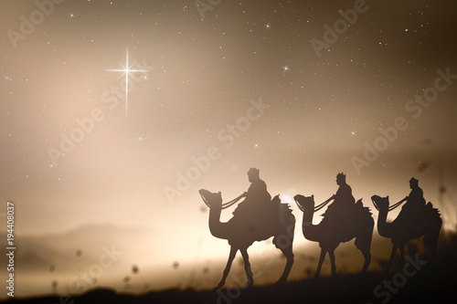 Fotografía Christmas religious nativity concept: Prophecy magi and his friend with three camel on desert was going to bethlehem city in christmas eve