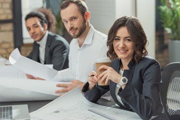 team of happy architects working together at modern office