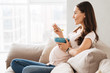 © Drobot Dean - Smiling pregnant young woman having healthy breakfast