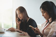 © silatip - Young woman worker talking with smartphone in office