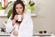 © Stocked House Studio - young woman relaxing and drinking a cup of tea at spa salon