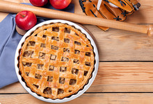 Delicious American Apple Pie With Baseball Equipment On Table