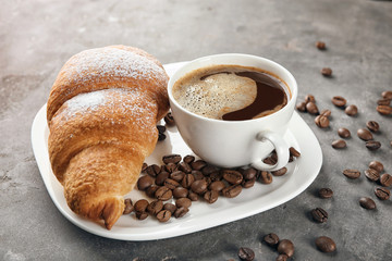 Sticker - Plate with tasty croissant and cup of coffee on table