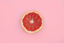 Pink Grapefruit Half On Bright Pink Background