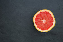 Pink Grapefruit On Dark Background With Copy Space