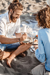 Wall Mural - People Enjoying Food on Beach Picnic