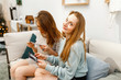 © EdNurg - girls friends relaxing and looking at the photo album in their apartment