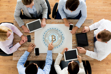 Wall Mural - business team with bitcoin holgram at table