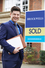 Wall Mural - Male Realtor Standing Outside Residential Property With Sold Sign