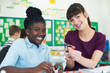 © highwaystarz - Portrait Of Female Pupil And Teacher Using Molecular Model Kit In Science Lesson