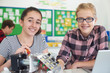 © highwaystarz - Portrait Of Female Pupils Studying Robotics In Science Lesson