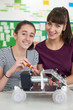 © highwaystarz - Portrait Of Teacher With Female Pupil Studying Robotics In Science Lesson