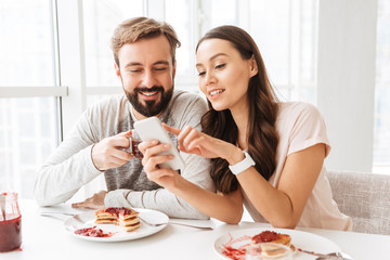 Wall Mural - Beautiful young couple having breakfast