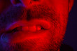 Macro close up on man with seductive facial expression biting his lips