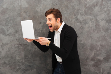 Sticker - Portrait of an excited young man dressed in shirt