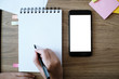 © Charlie's - girl using smart phone in office. hand holding smart phone white screen.
