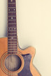 © ink drop - Wooden acoustic guitar against a plain background
