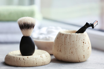 Shaving brush and razor for man on table