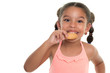 Cute small multiracial girl  eating a cookie - Isolated on white