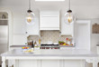 © Trinette Reed/Stocksy - Kitchen with food and wine on counter in luxury home