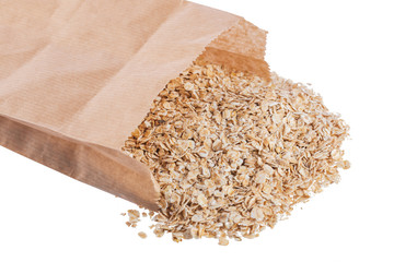 Wall Mural - Oat flakes heap in paper packet isolated on a white background