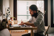 © Dimitrije Tanaskovic/Stocksy - Man working at home
