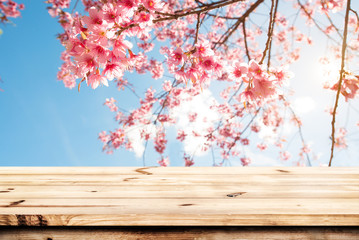 Wall Mural - top of wood table empty ready for your product and food display or montage with pink cherry blossom 