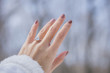 © Alinnan - Close up of an elegant engagement diamond ring on woman finger with white sweater winter clothe background. love and wedding concept. soft and selective focus.
